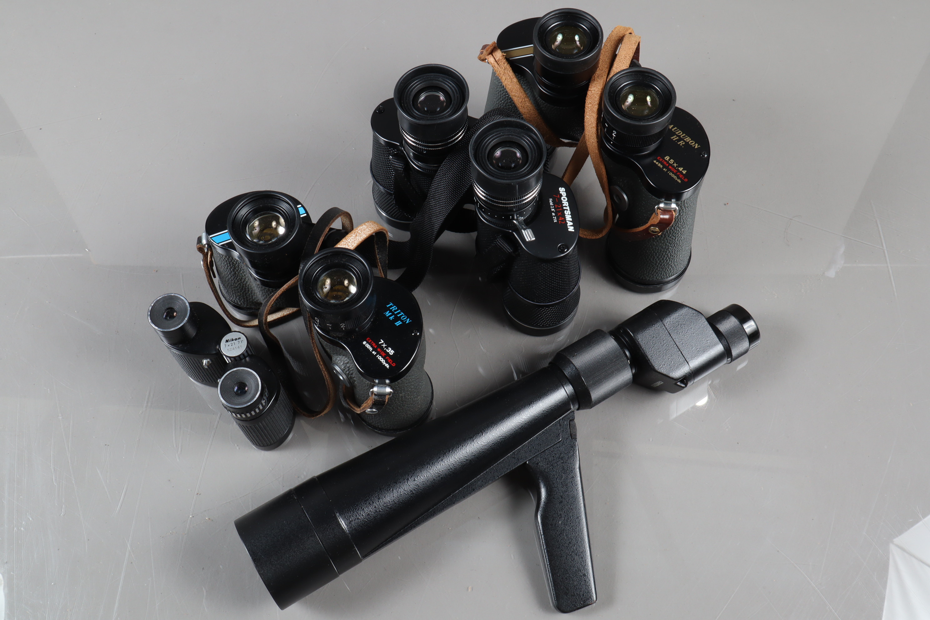 A Group of Binoculars, a pair of Nikon z x 21 7.1° compact binoculars, a Pair of Miranda Sportsman