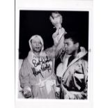 HENRY COOPER AUTOGRAPH A 10" X 8" b/w photo of Muhamad Ali holding up Cooper's arm after their