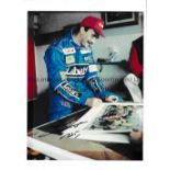 NIGEL MANSELL AUTOGRAPHS Two signed colour photos of Mansell in Williams colours. One photo has a