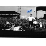 TOMMY DOCHERTY / AUTOGRAPH A 12 X 8 photo of the Preston right-half evading a challenge from an