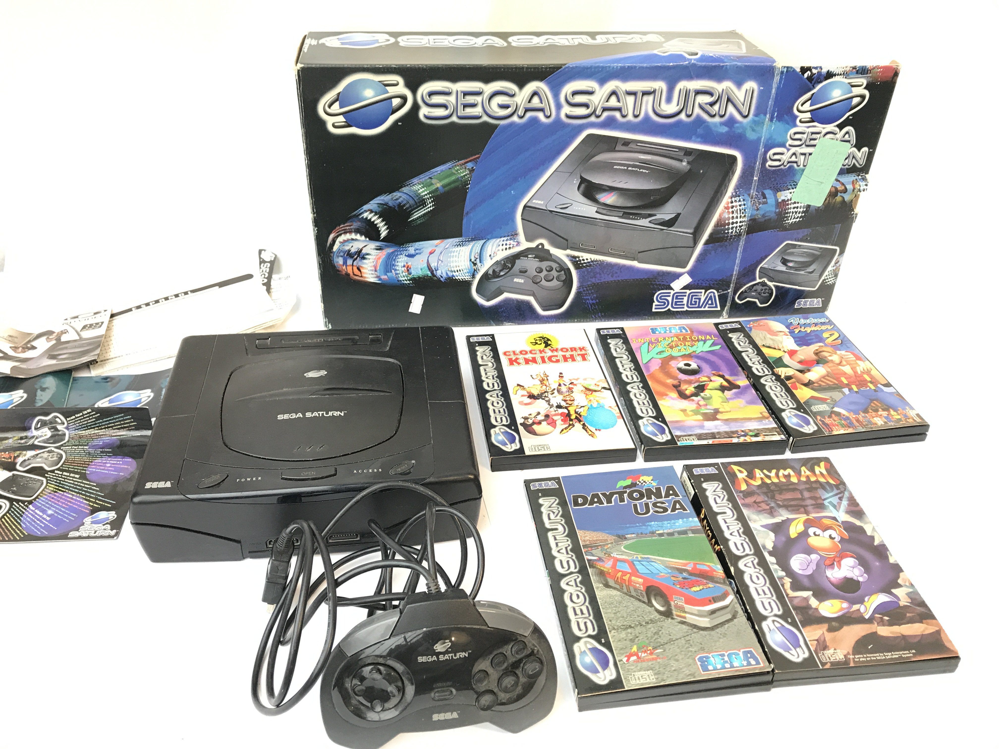 Boxed Sega Saturn and 5 games.