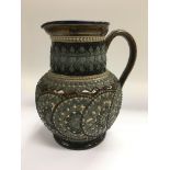 A large Doulton Lambeth jug heavily decorated in b