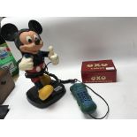 A vintage Micky Mouse figure and toy telephone, an