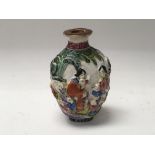 A Chinese hand painted relief decorated snuff bott