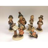 Six Goebel Hummel figures of children.