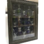 A framed display collection of antique eye bath gl