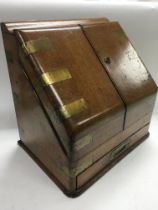 A brass bound oak stationary box with fitted inter