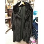 A Marno Mini ladies simulated fur long black coat.