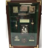 A framed glass fishing display including cased ant