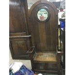 A wooden hall stand with a lift up storage seat an