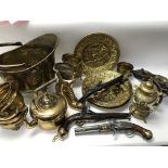 A collection of brassware including a small canon