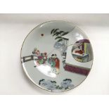 A Chinese plate painted with various figures in a