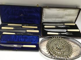 Two cased carving sets, a round brass trivet, a Vi