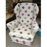 A Retro design arm chair with conforming later uph