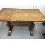 A low oak occasional table carved with a single ac