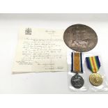 A WW1 memorial plaque and medal duo in memorium of