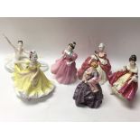 Four Royal Doulton figurines (one with damage), on