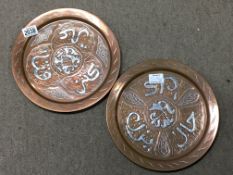 A pair of copper and silver inlaid eastern style t