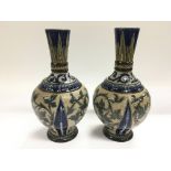 A pair of Doulton Lambeth vases with foliate decor