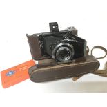 A left handed Zeiss Ikon vintage camera in a leath