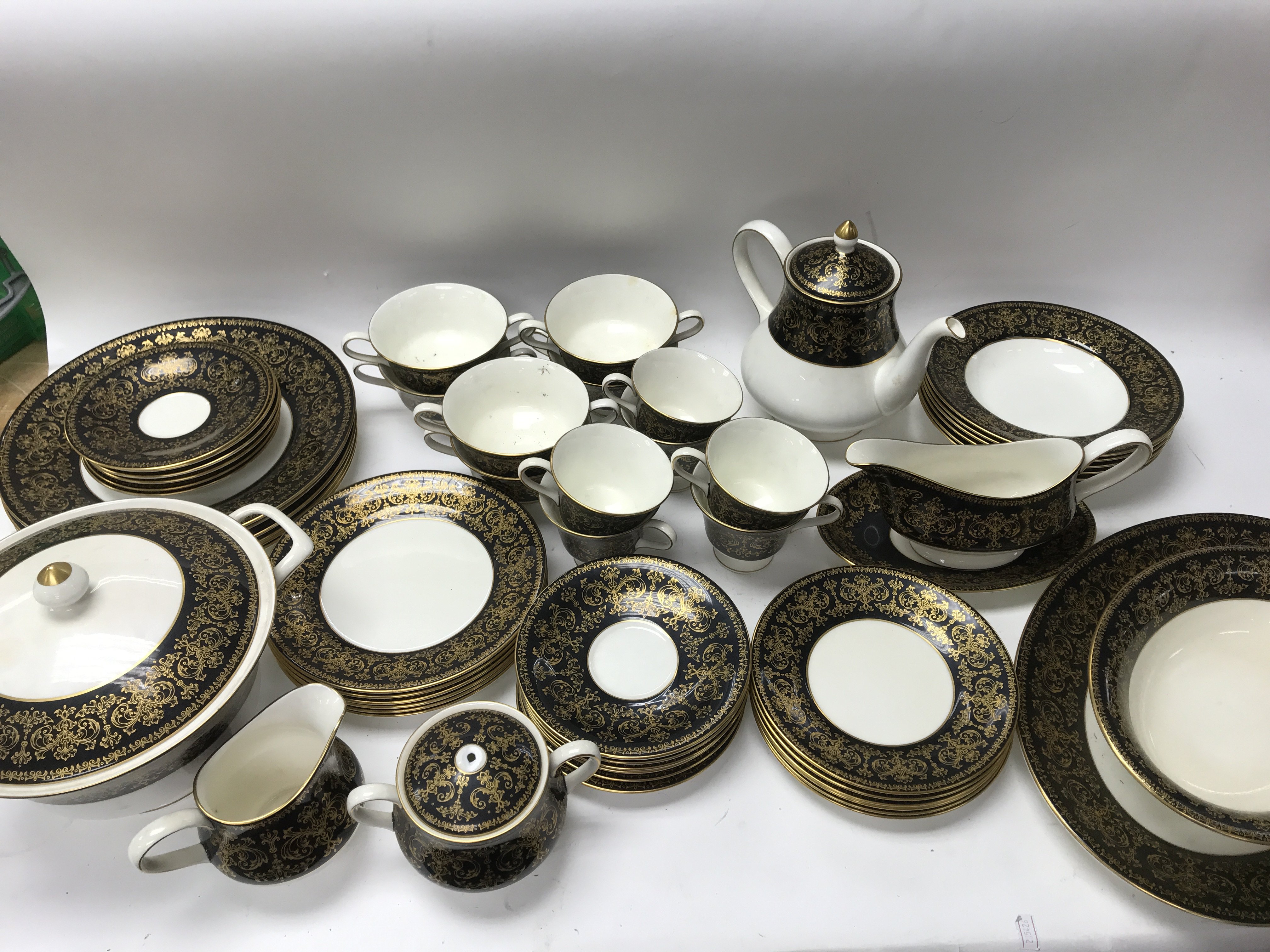 A Wedgwood black and gold part dinner and tea set.