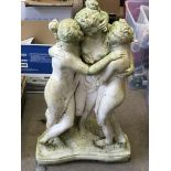 A composition garden ornament depicting a trio of