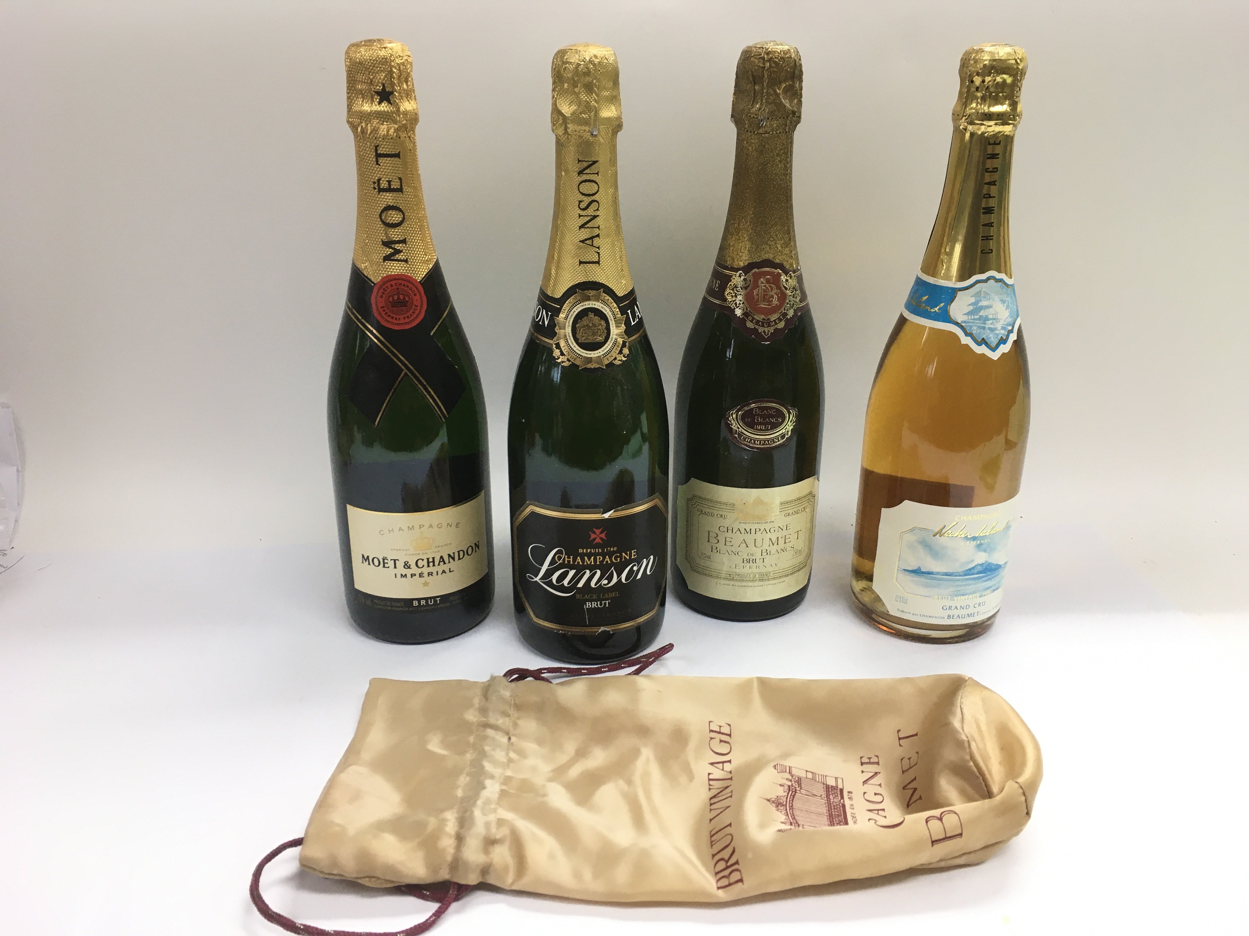 Four bottles of champagne including Moet & Chandon