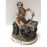 A capodimonte figure of a blacksmith, with origina