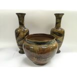 A pair of Doulton Lambeth vases with a brown leaf