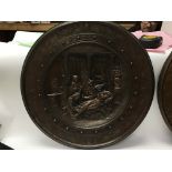 Two circular bronze plaques, one depicting an Anci