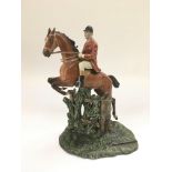 A cold painted metal figural table match strike depicting a huntsman on horseback, approx height 19c