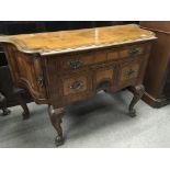 An English inlaid walnut cabinet the shaped top ab