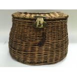 A vintage cane fishing basket with brass fittings.