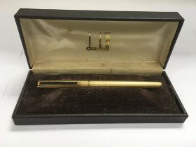 A boxed Dunhill fountain pen with a 14k gold nib.