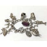 A heavy silver charm bracelet, weighing approximat