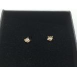 A pair of boxed 18ct rose gold four claw set diamo