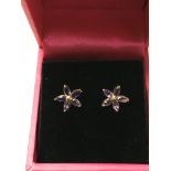 A pair of 9ct gold earrings set with amethyst in t