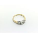 An 18ct yellow and white gold three stone princess