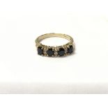 A 9ct gold ring set with alternating diamonds and