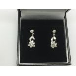 A pair of boxed 18ct white gold daisy style diamon