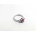 An 18ct white gold three stone pink sapphire and d