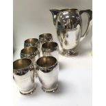 A silver plate water set including 6 beakers and a