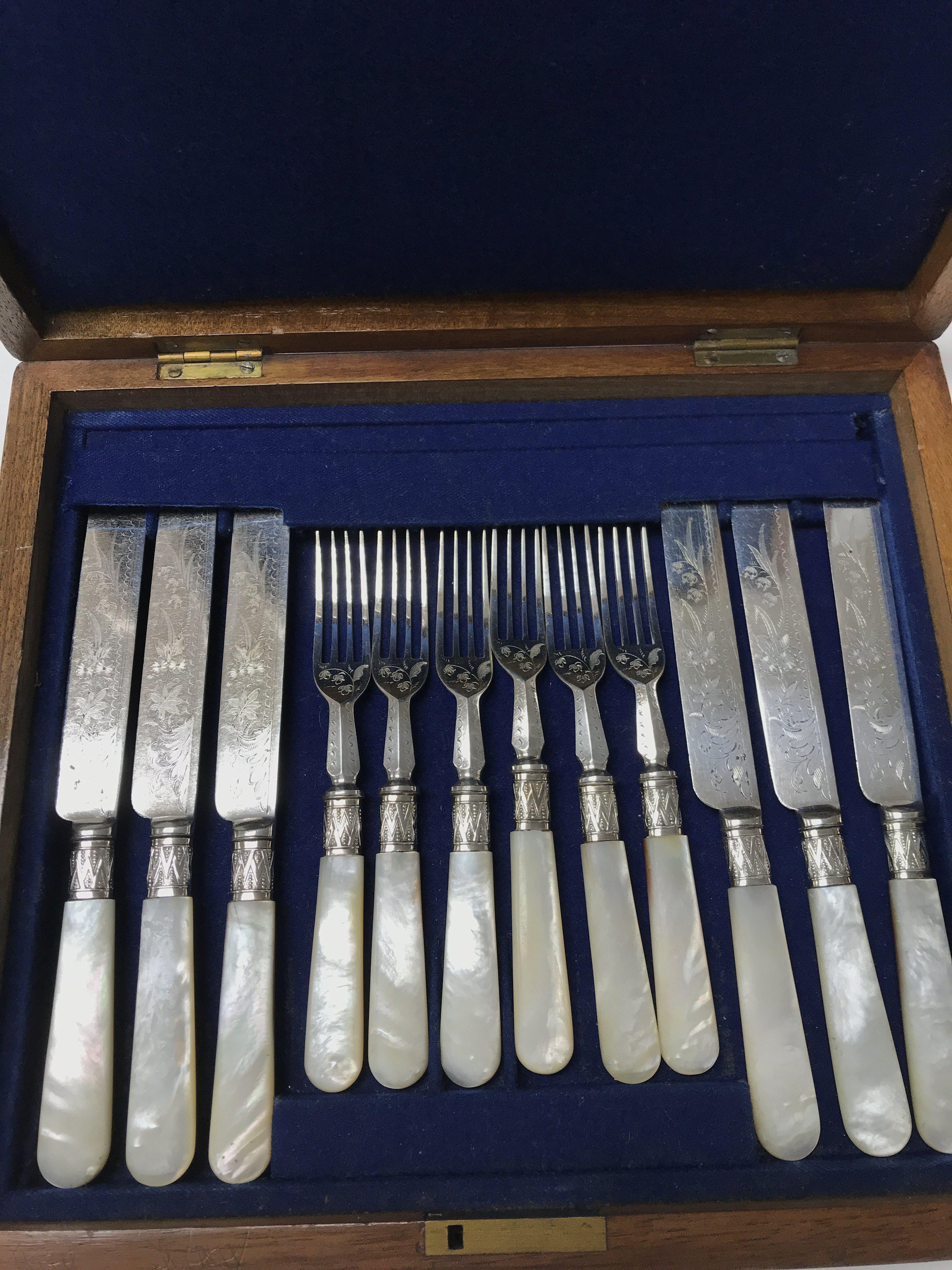 A walnut cased canteen of mother of Pearl cutlery.