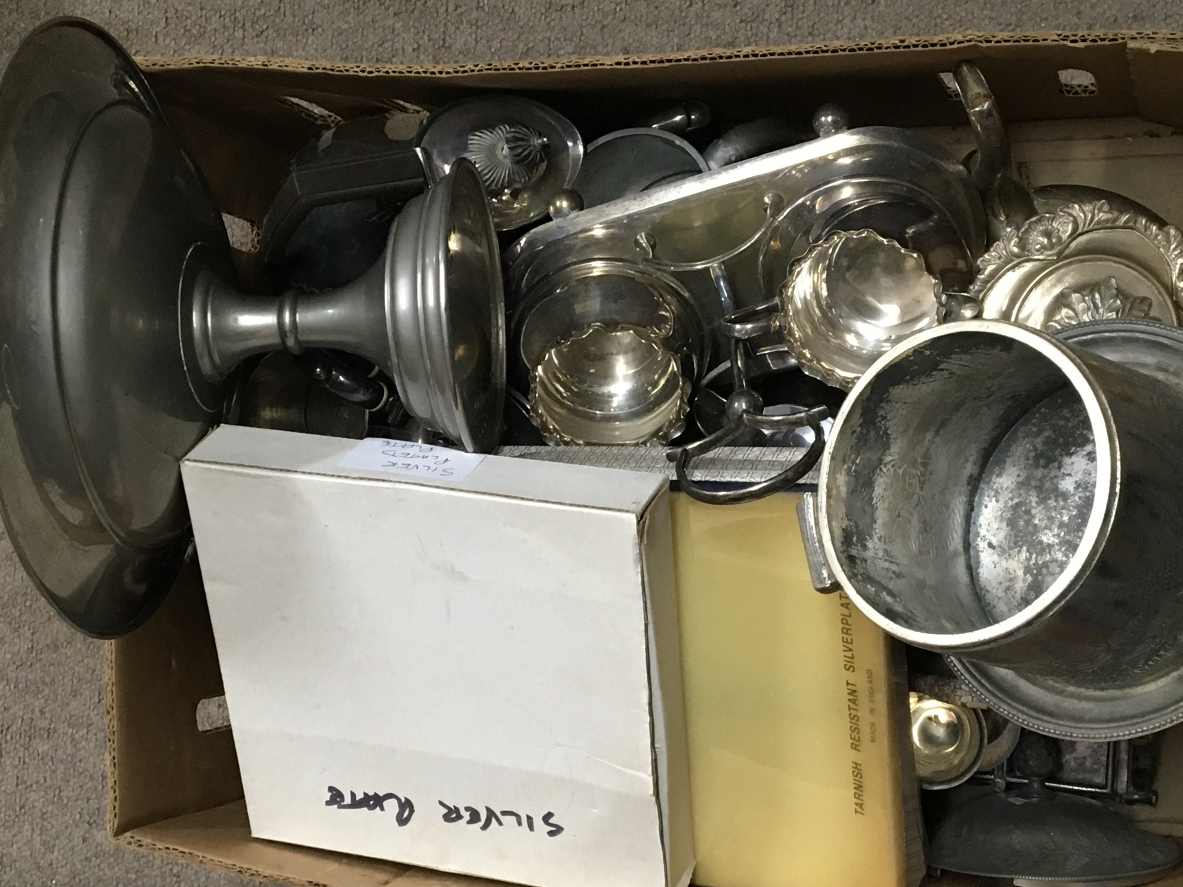 A box containing a collection of silver plate and