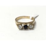 A sapphire and diamond three stone 9ct gold ring.