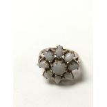 A 9ct gold opal ring in the shape of a flower. The