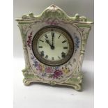 A Edwardian mantel clock with pottery floral case