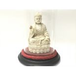 A good old vintage figure of a Buddha under a glas
