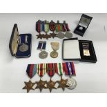 A Collection of WW2 service medals; a Naval rosett