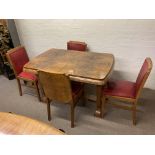 An Art Deco walnut dining table with 4 matching upholstered chairs and a matching sideboard.
